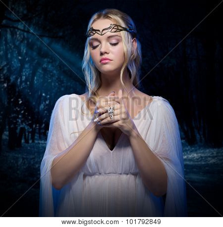 Young elven girl at night forest