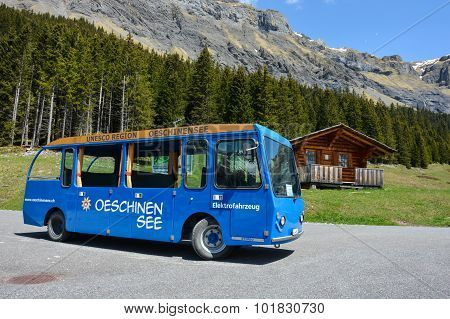 Electric Tourist Bus With Wooden Chaletclose To Oeschinensee, Switzerland.