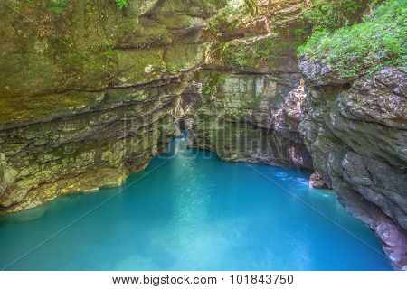 Okatse canyon (Georgia): picturesque rocks hang out over the azure river.