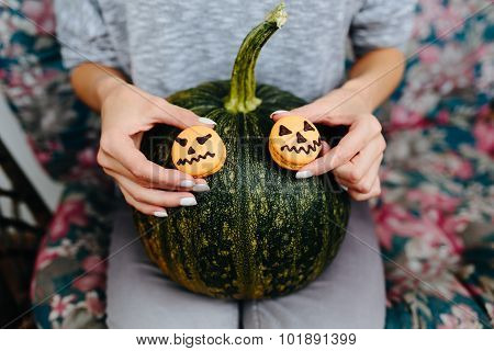woman holding a biscuit for Halloween