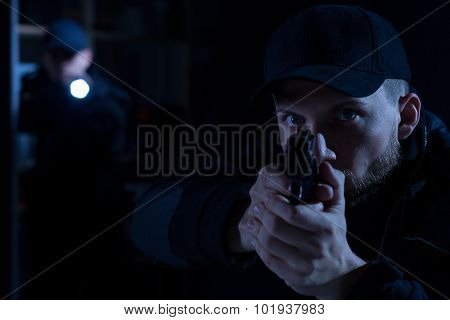 Officer Pointing Gun At Criminal