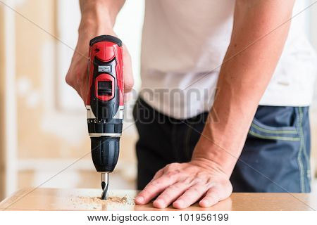 Craftsman or DIY man working with power drill