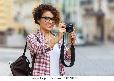 Nice girl holding photo camera