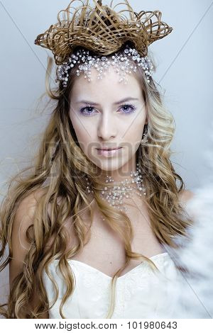 beauty young snow queen in fairy flashes with hair crown on her head close up