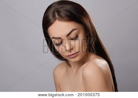 Eyelashes extensions. Fake Eyelashes. Closeup Of Beautiful Young Female Model With Soft Smooth Skin And Professional Facial Makeup. Portrait Of Sexy Girl With Long Fake Eyelashes And Perfect Make-up.