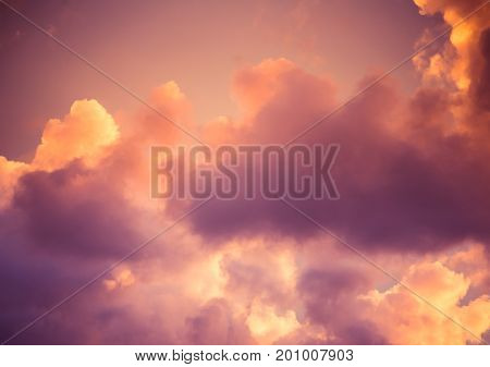 Magnificent colorful clouds in the evening sky. Bright pink clouds in the sky at sunset. Beautiful evening skyscape. Abstract purple pink background. Vibrant color photograph.