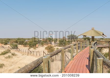 ETOSHA NATIONAL PARK NAMIBIA - JUNE 26 2017: View of the Olifantsrus Rest Camp in the Etosha National Park as seen from the elevated walkway to the hide at the waterhole