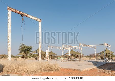 ETOSHA NATIONAL PARK NAMIBIA - JUNE 26 2017: Structures of the old elephant abattoir at the Olifantsrus Rest Camp in the Etosha National Park. Picnic sites for day visitors are visible in the back