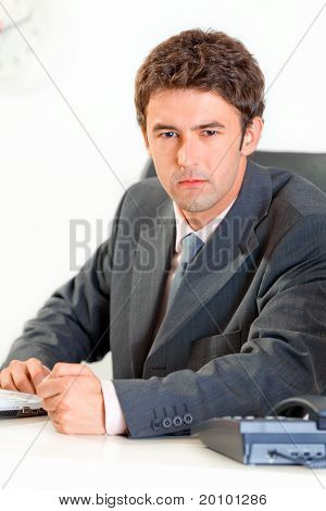Angry modern business man banging fist on table