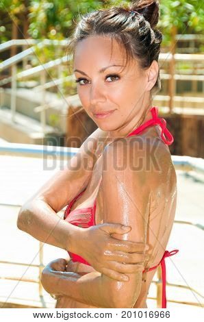Happy girl with mud mask in Mud Bath, Dalyan, Turkey.