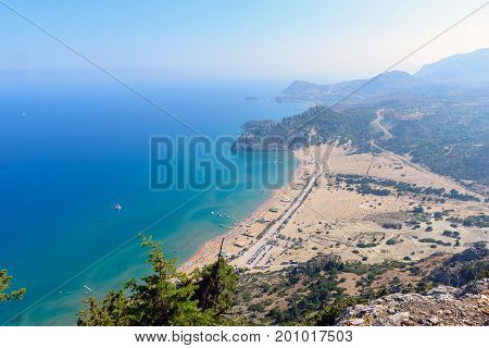 Aerial view on Tsampika sandy beach and lagoon with clear blue water at Rhodes island, Greece.