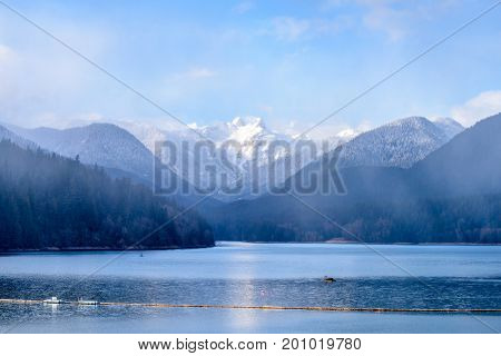 Snow Mountains and Capilano Lake at fog in Vancouver British Columbia Pacific Northwest.