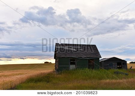 An image of an old abandoned homestead on the prairies.