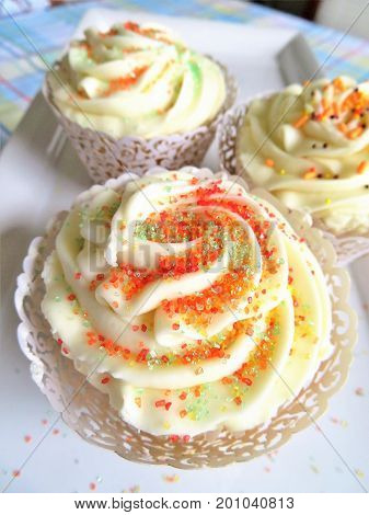 Cupcakes decorated with a vanilla frosting and sprinkles for birthdays weddings or showers