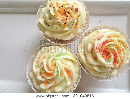 Cupcakes decorated with a vanilla frosting and sprinkles for birthdays weddings or showers