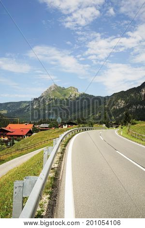 Road in the Tyrolean Alps in the direction of the mountain Aggenstein