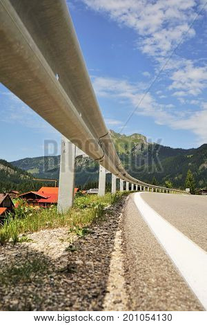 Road in the Tyrolean Alps in the direction of the mountain Aggenstein