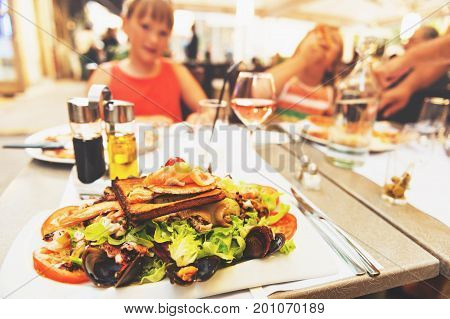 Seafood salad served in the restaurant family dining outside during summer vacation on south of France