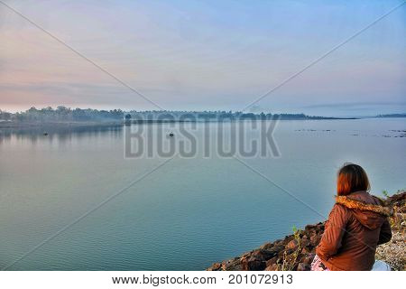 In the morning, the weather is very good. The woman is looking dam beautiful Mimi nampoong views.