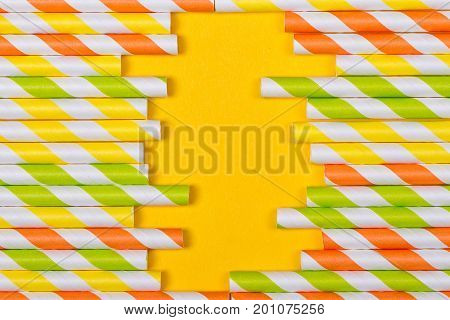 close-up colorful fancy drinking straws fancy tube for party on the yellow background