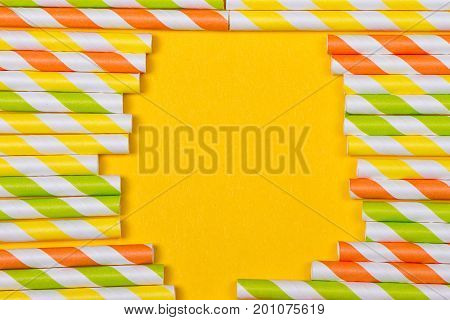 close-up colorful fancy drinking straws fancy tube for party on the yellow background