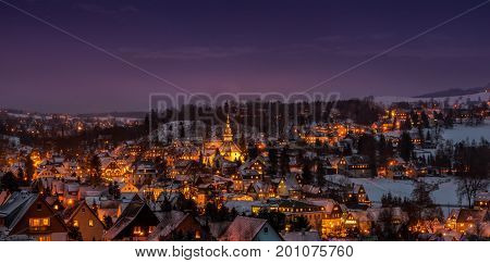 Illuminated houses in Seiffen at Christmas Time .