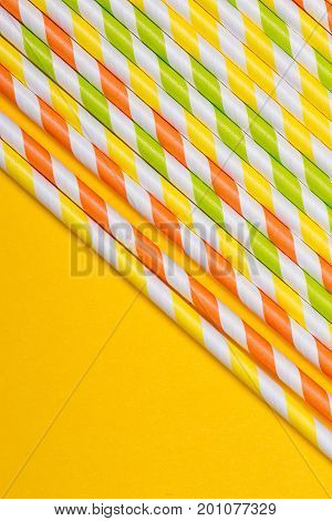 close-up colorful fancy drinking straws fancy tube for party on the yellow background