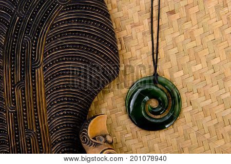 New Zealand - Maori Themed Objects - Mere And Greenstone Pendant On Woven Kite Flax Background