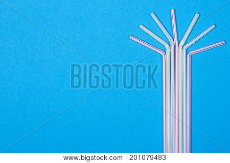 close-up colorful fancy drinking straws fancy tube for party on the blue background