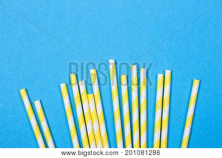 close-up colorful fancy drinking straws fancy tube for party on the blue background