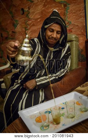 Man In Traditional Clothes Preparing Mint Tea, Morocco