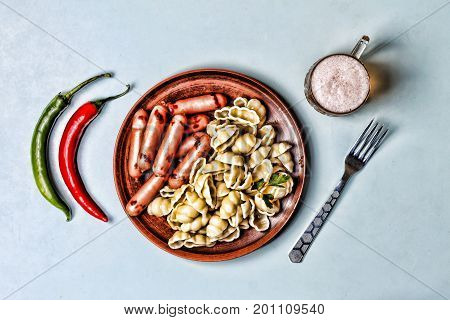 Minimalism stil. Snack or lunch. Pasta sausages of barbecue beer hot chili pepper
