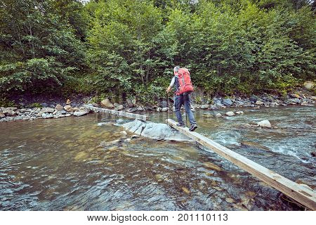 Hiking in the mountains with a backpack in the summer.