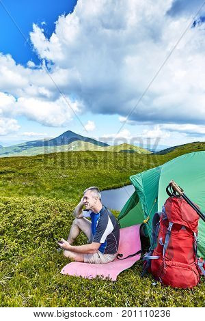 Hiking in the mountains with a backpack in the summer.