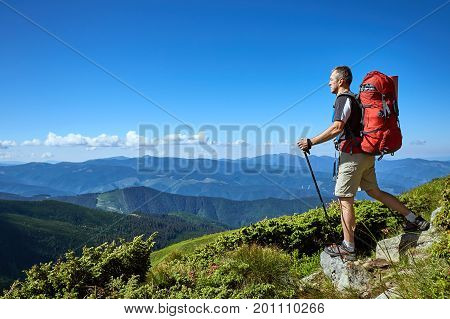 Hiking in the mountains with a backpack in the summer.