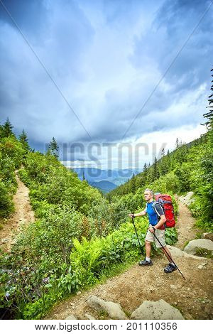 Hiking in the mountains with a backpack in the summer.