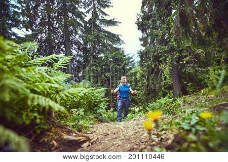 Hiking in the mountains with a backpack in the summer.