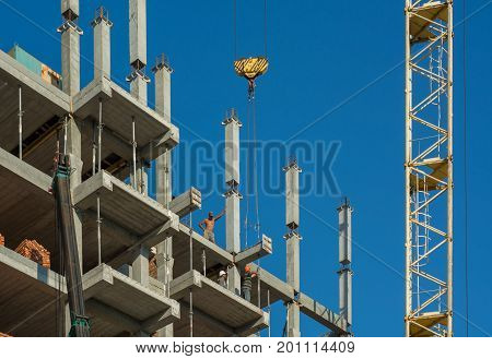 Builders with crane building a new house