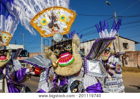 PUNO, PERU - AUGUST 07: Authentic Colorful Carnival on the streets of Puno, Peru near the high altutude Titicaca lake on August 7th, 2017