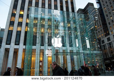 NEW YORK CITY - Dec 16, 2010:  Apple Store cube on 5th Avenue. Apple logo at Apple store on 5th ave. the glass front of the store looking up at logo in Manhattan, Dec 16, 2010 in New York City, USA.