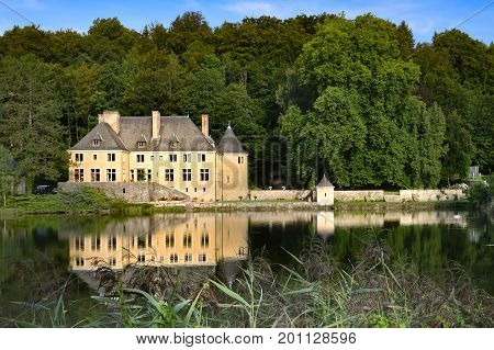 Chateau on a pond in villers front orval in the countryside gaumaise