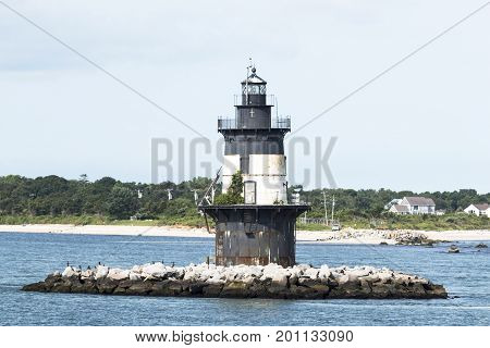 Orient Point is view behind the Orient Point lighthouse at the point where the Long Island Sound and Peconic Bay meet.