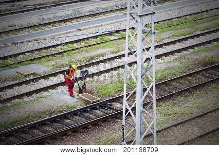 Railroad switch. Railwayman using switch. Train infrastructure