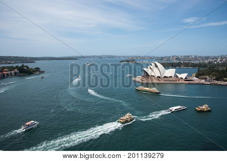 SYDNEY,NSW,AUSTRALIA-NOVEMBER 20,2016: Sydney Opera House at Bennelong Point with nautical vessels and waterfront housing in Sydney, Australia