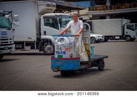 TOKYO, JAPAN JUNE 28 - 2017: Unidentified old man driving a cargo machine outside in Fish Tsukiji Market is the biggest wholesale fish and seafood market in the world, in Tokyo, Japan.