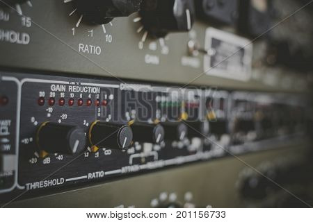 Studio equipment for recording and mixing. Compressor. Selective focus.
