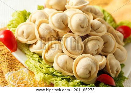 Frozen Dumplings On The White Plate With Green