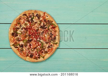 Pizza on wooden. Wooden table top view. On the table are the food for cooking. Healthy food. Dietetic foods. Above view on food. Hot Homemade Pepperoni Pizza Ready to Eat