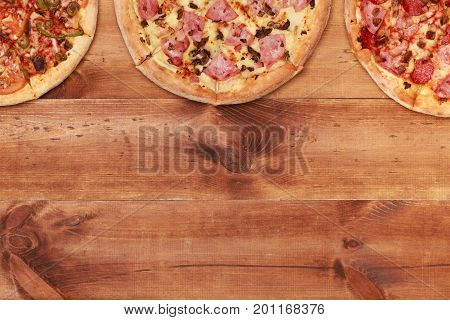 Pizza on wooden table top view. Fast food Delicious. Post blog social media. View from above with copy space. Banner template layout mockup top view on pizza. Pizza ready to eat.