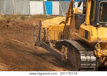 Excavator working on a construction site. Yellow Construction bulldozer at Work. Construction of a new road